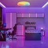 A modern bedroom with a gaming setup and a bed, illuminated by colorful LED lights. Náhľad obrázku produktu
