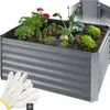 A raised garden bed filled with various plants and vegetables, with gardening gloves in the foreground. Náhled obrázku produktu