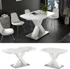 A white dining table with a unique X-shaped base is shown from multiple angles, including a lifestyle shot with chairs and a decorative vase, and isolated views highlighting its structure and extendable feature. Anteprima dell’immagine prodotto