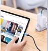 A hand is holding a tablet that is charging via a USB-C cable plugged into a wall adapter. Produktbild-Vorschau