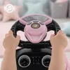 A child's hands are holding the steering wheel of a pink toy car. Produktbild-Vorschau