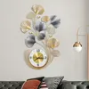 A decorative wall clock with a floral design is mounted on a wall above a sofa. Produktbild-Vorschau