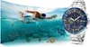 A swimmer in the ocean next to a watch. Produktbild-Vorschau