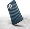A dark blue phone case with a ribbed texture is shown falling onto a concrete surface, with dust and debris scattering around it. Produktbild-Vorschau
