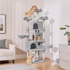 A tall, multi-level cat tree with several cats interacting with it in a living room setting. Produktbild-Vorschau