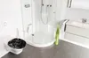 A modern bathroom with a toilet, shower, and vanity. Produktbild-Vorschau