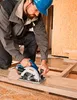 A person is using a circular saw to cut a wooden plank. Produktbild-Vorschau