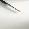 A close-up of a paintbrush on a textured white surface. Produktbild-Vorschau