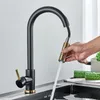 A hand is holding a pull-down faucet head, with water spraying into a sink. Cucumbers are on a cutting board next to the sink. Náhľad obrázku produktu