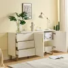 A white sideboard with gold accents in a room with light yellow walls. Produktbild-Vorschau