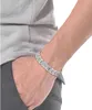 A close-up shot of a person's arm wearing a silver bracelet. Náhled obrázku produktu
