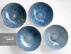 Four blue ceramic bowls are arranged on a white surface. Produktbild-Vorschau