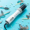 A hair dryer is placed on a light blue background surrounded by feathers and small white objects. Náhled obrázku produktu