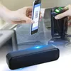 A hand holding a smartphone with a QR code is being scanned by a barcode scanner, with a black speaker in the foreground. Produktbild-Vorschau