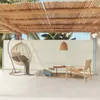 An outdoor patio area with furniture and a retractable side awning. Podgląd zdjęcia produktu