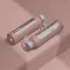 Two pink glass water bottles with gray lids and white straps are placed on a pink surface, with soft shadows. Náhľad obrázku produktu