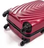 A close-up view of the bottom corner of a red suitcase with wheels. Podgląd zdjęcia produktu