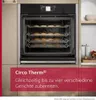 A built-in oven with multiple racks of cookies inside, set in a modern kitchen environment. Produktbild-Vorschau