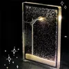 A decorative snow globe with a street lamp and snow effect, set against a black background. Produktbild-Vorschau