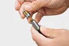 Hands assembling a metal nozzle attachment. Produktbild-Vorschau