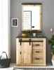 A wooden sideboard with sliding doors and drawers, placed against a gray wall, with a mirror and decorative items above it. Produktbild-Vorschau
