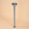 A silver bollard light with a round top, standing on a plain peach background. Produktbild-Vorschau