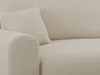 A close-up view of a textured beige sofa with a cushion. Produktbild-Vorschau