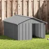 A gray metal dog house sits on a green lawn in front of a wooden fence. Podgląd zdjęcia produktu