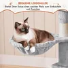 A Siamese cat is resting in a plush hammock attached to a cat tree. Produktbild-Vorschau
