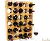 A wooden wine rack filled with wine bottles, with a glass of red wine next to it. Produktbild-Vorschau