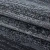 A close-up view of a folded rug with a textured linear pattern. Produktbild-Vorschau