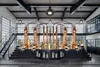 A large, industrial-style room with copper distillation equipment. Anteprima dell’immagine prodotto