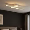 A modern white ceiling light fixture with curved LED elements. Náhled obrázku produktu