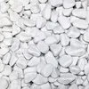 A close-up, overhead view of a pile of white marble pebbles. Produktbild-Vorschau
