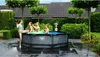 Children playing in a round swimming pool in a backyard. Náhled obrázku produktu