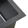 A close-up view of the corner of a black stainless steel sink. Produktbild-Vorschau