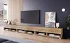 A modern living room with a TV mounted on the wall above a long, wooden TV stand. Voir les images du produit