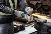 A person is using an angle grinder to cut metal rebar, with sparks flying. Náhľad obrázku produktu