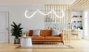 A modern living room with a sofa, coffee table, and a kitchen area separated by wooden slats. Produktbild-Vorschau