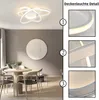 A modern dining area with a round table and chairs, featuring a stylish ceiling light. Náhľad obrázku produktu
