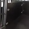 Close-up view of the interior of a black dog crate, showing the hinges and latches of a divider. Produktbild-Vorschau