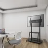 A modern office or meeting room setting with a desk, chair, and a large screen on a mobile stand. Náhľad obrázku produktu