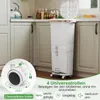 A white kitchen trash can with multiple compartments and a pedal is shown in a kitchen setting. Anteprima dell’immagine prodotto