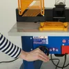 A person's arm is visible, operating a woodworking machine. Produktbild-Vorschau