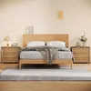 A bedroom scene with a wooden bed, nightstands, and a rug. Produktbild-Vorschau