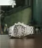 A silver Guess watch with a black face is displayed on a wooden surface. Náhled obrázku produktu