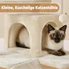 A Siamese cat is resting inside a beige cat condo. Produktbild-Vorschau