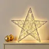A decorative star with lights sits on a dresser next to two golden Christmas ornaments. Produktbild-Vorschau