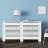 A white radiator cover with a shelf on top, placed against a light blue wall. Náhľad obrázku produktu