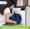 A woman is putting a blue cloth into a washing machine. There are two detergent bottles on top of the washing machine. Produktbild-Vorschau
